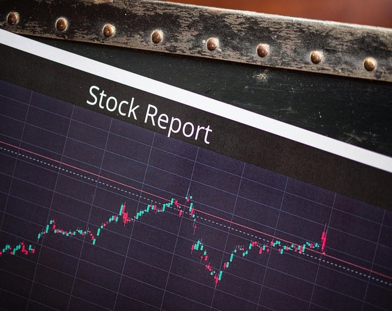 Screen shows a 'Stock Report' title with a dark grid stock chart showing fluctuating prices and candles/lines.
